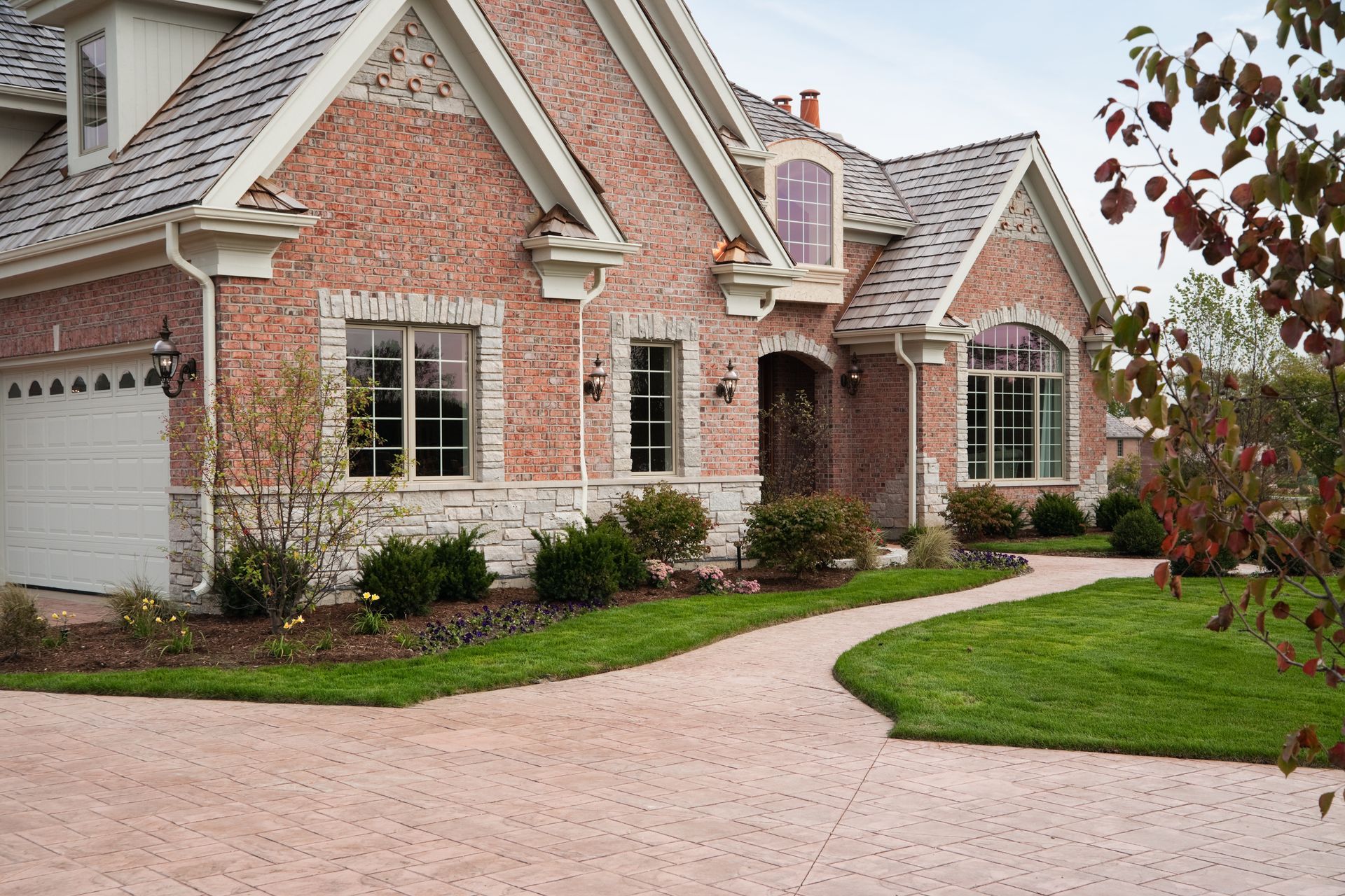 A large brick house with a white garage door