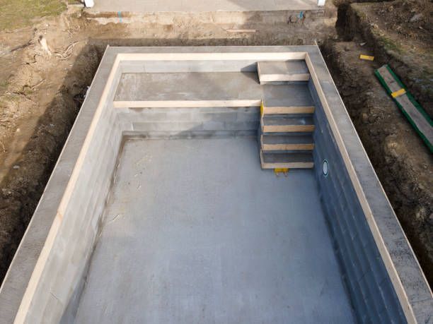 A swimming pool is being built in a hole in the ground.
