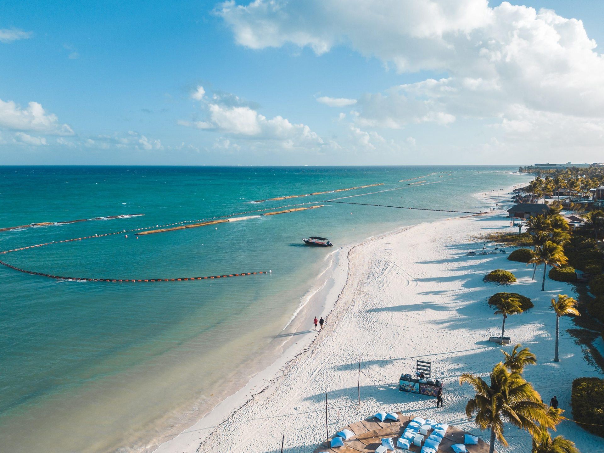 aerial view of a beach with calm surf and beachgoers