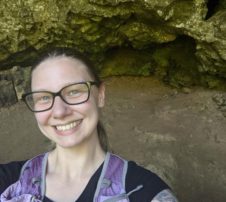 Selfie of Hailey from a day hike, taken in a shallow cave