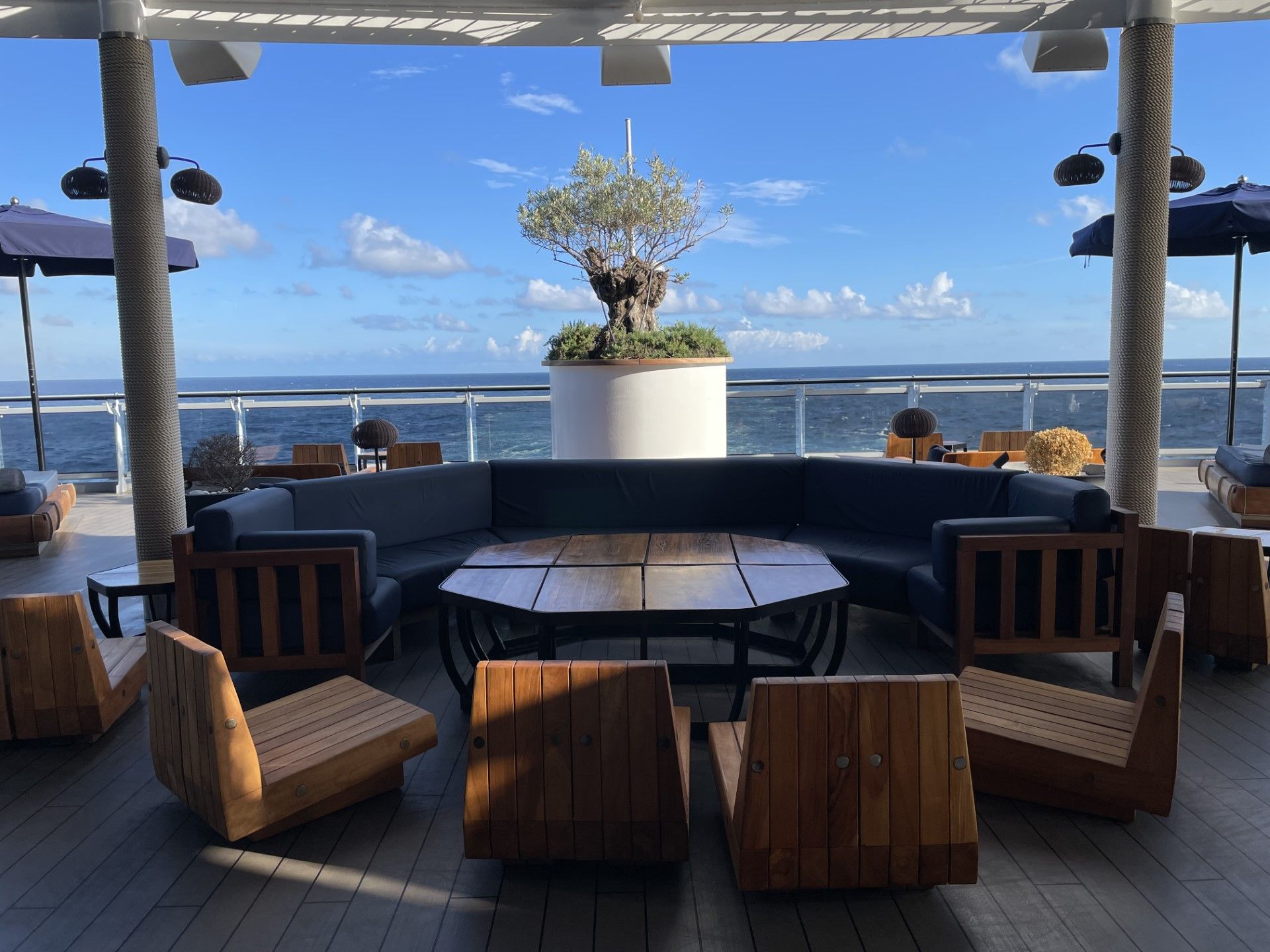 shaded outdoor lounge at the back of a cruise ship on a sunny day