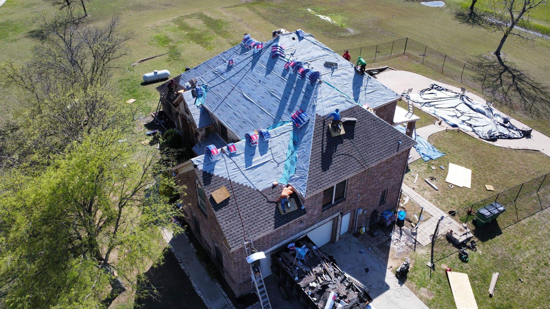 An aerial view of a roof being installed on a house.