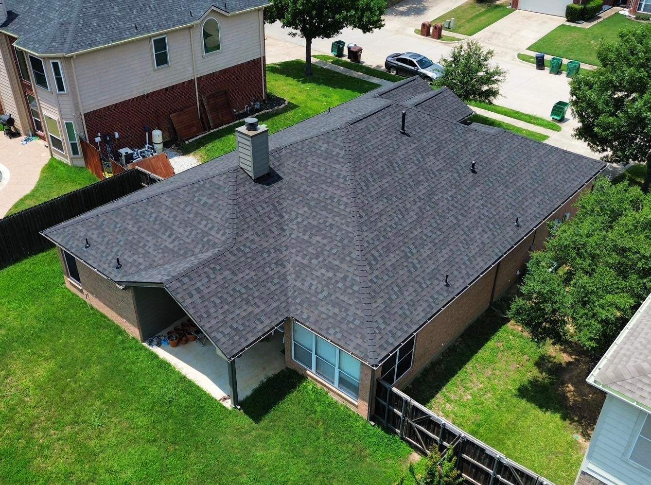 An aerial view of a house with a new roof.