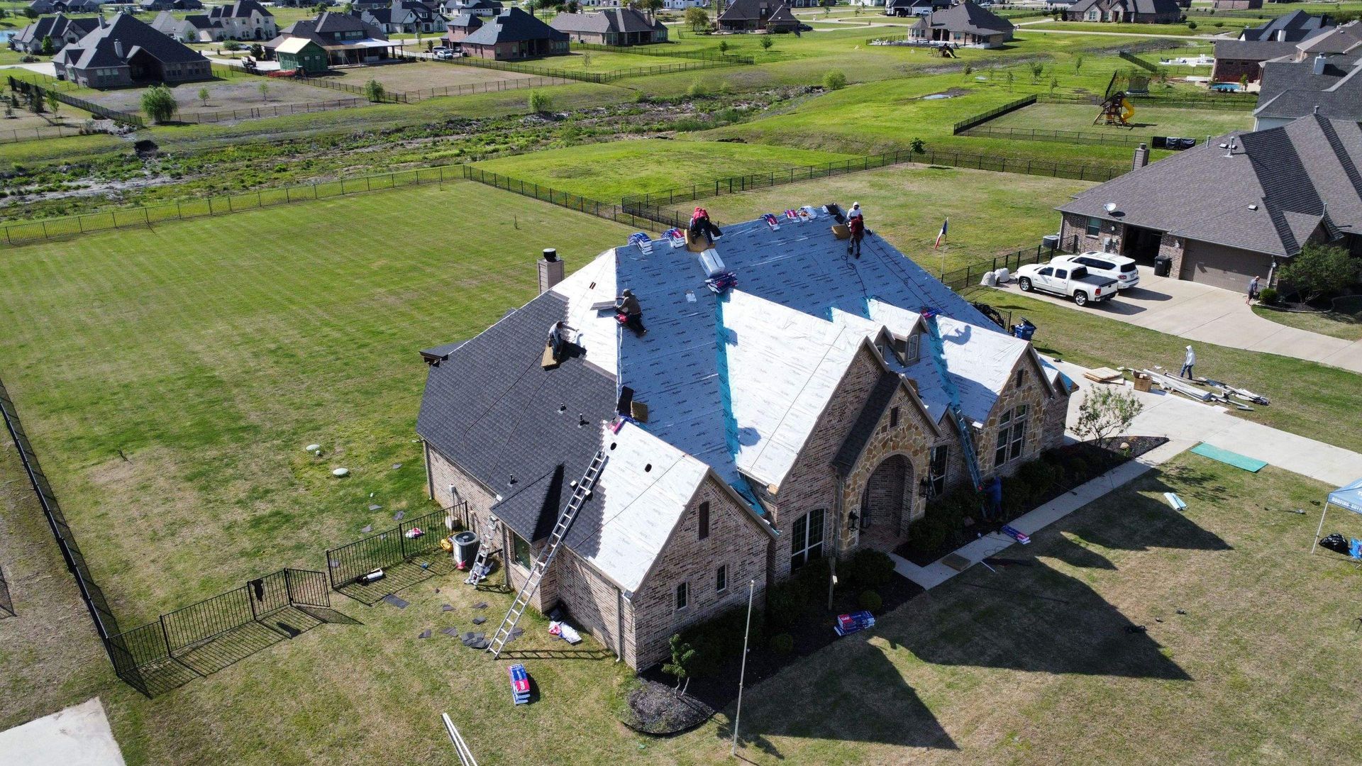 An aerial view of a house being remodeled with a new roof.