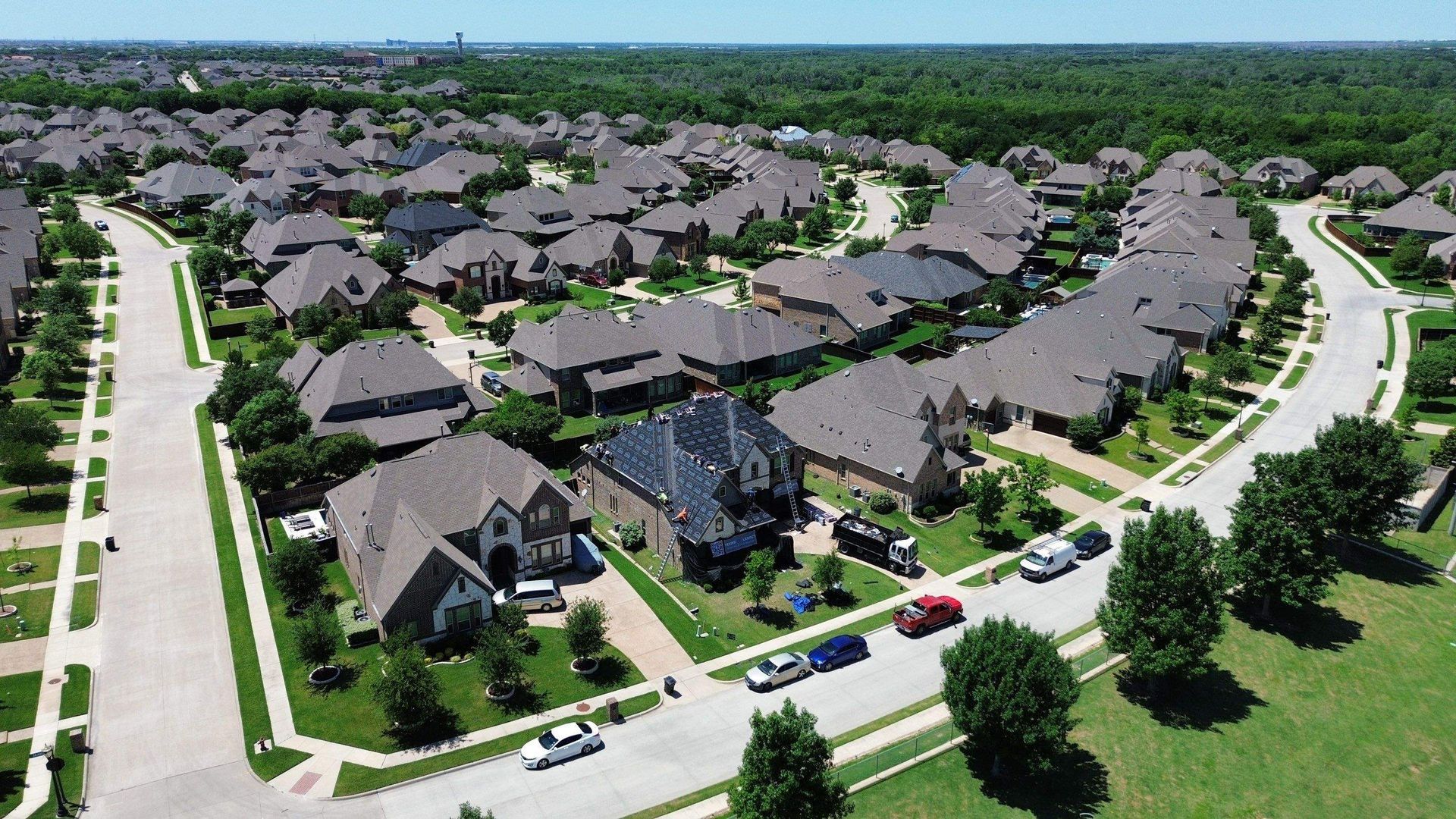An aerial view of a residential area with lots of houses and trees
