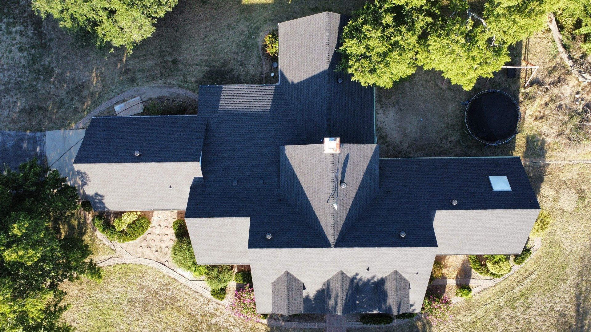 An aerial view of a house with a black roof