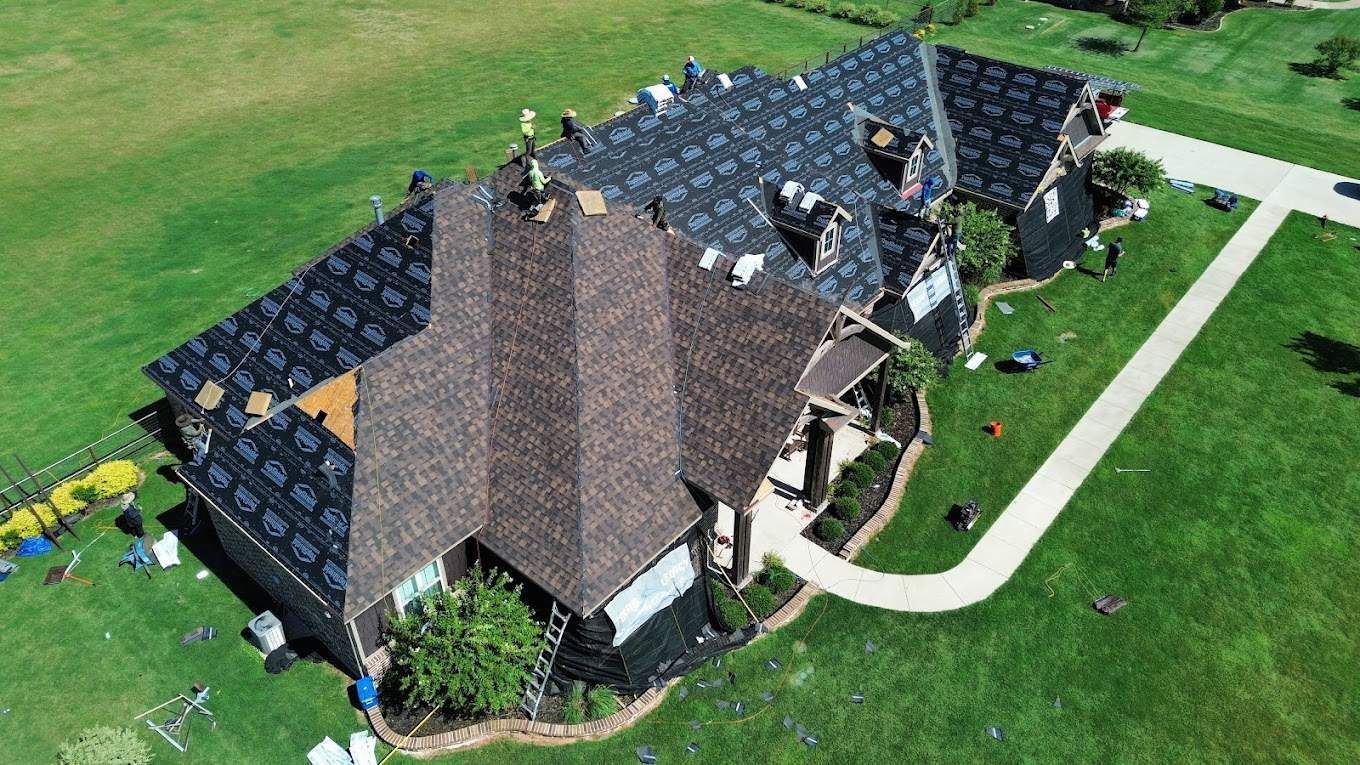 An aerial view of a house being remodeled with a new roof.