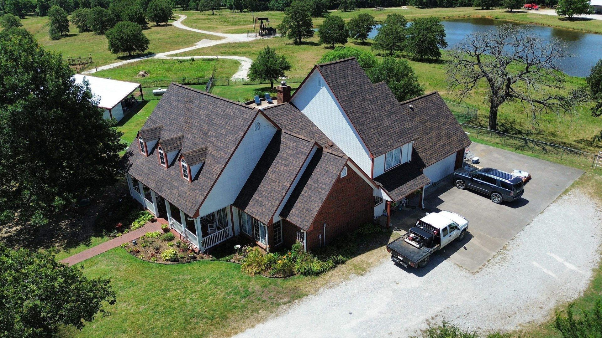 An aerial view of a house with a truck parked in front of it.