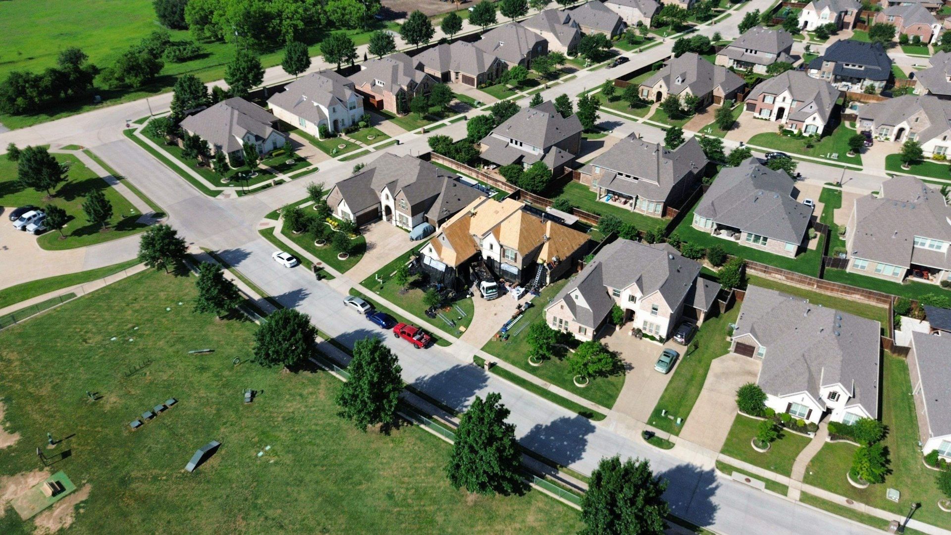 An aerial view of a residential neighborhood with lots of houses and trees
