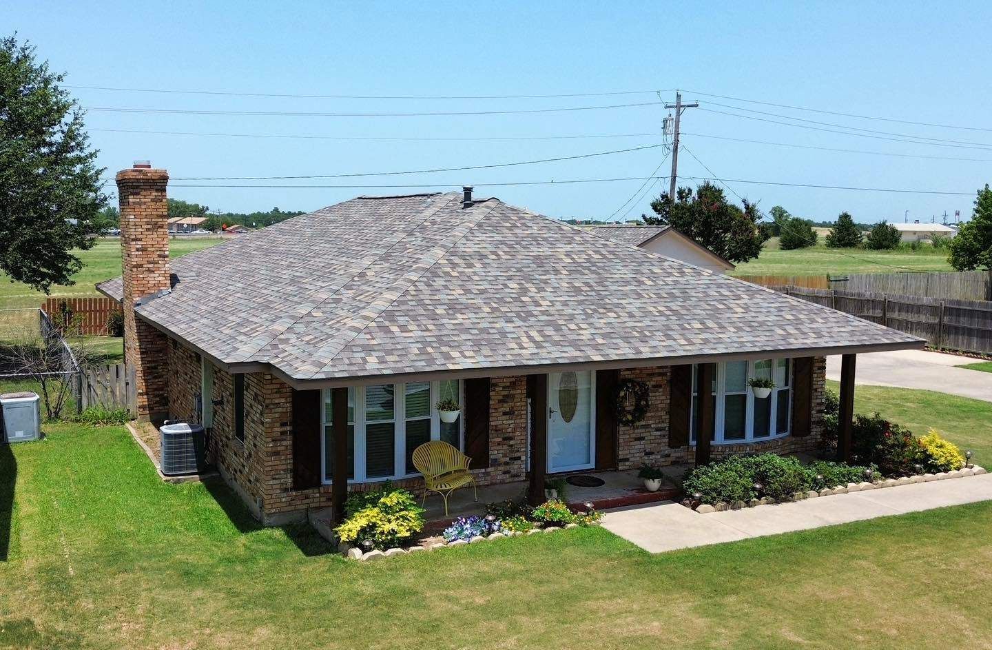 An aerial view of a house with a roof that is covered in shingles.