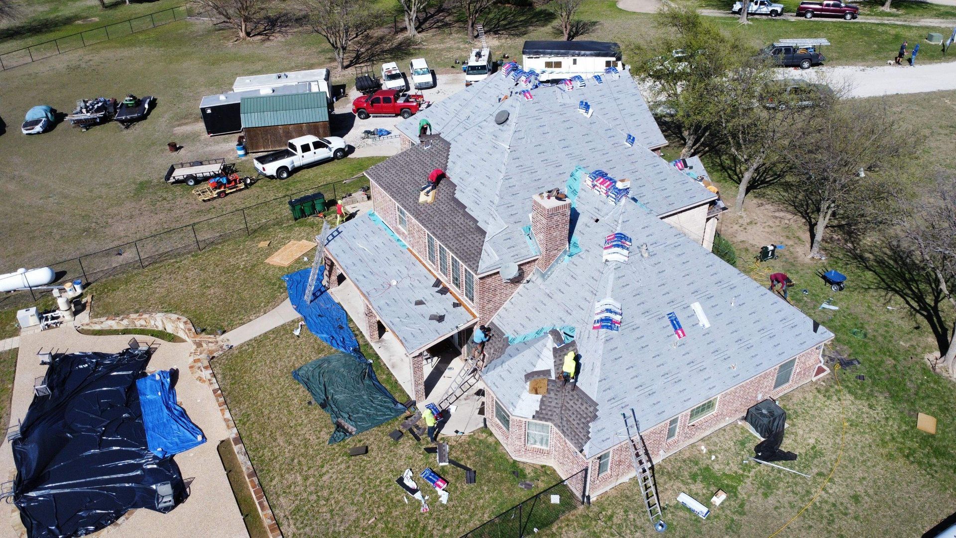 An aerial view of a large house being remodeled.