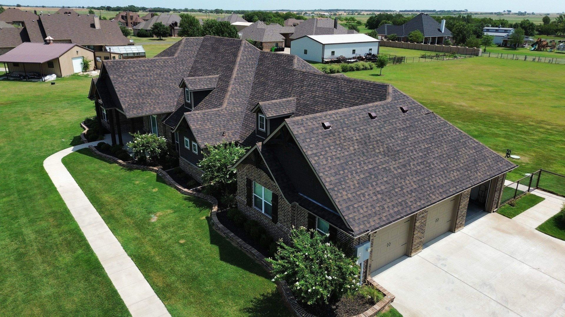 An aerial view of a large house in a residential area.