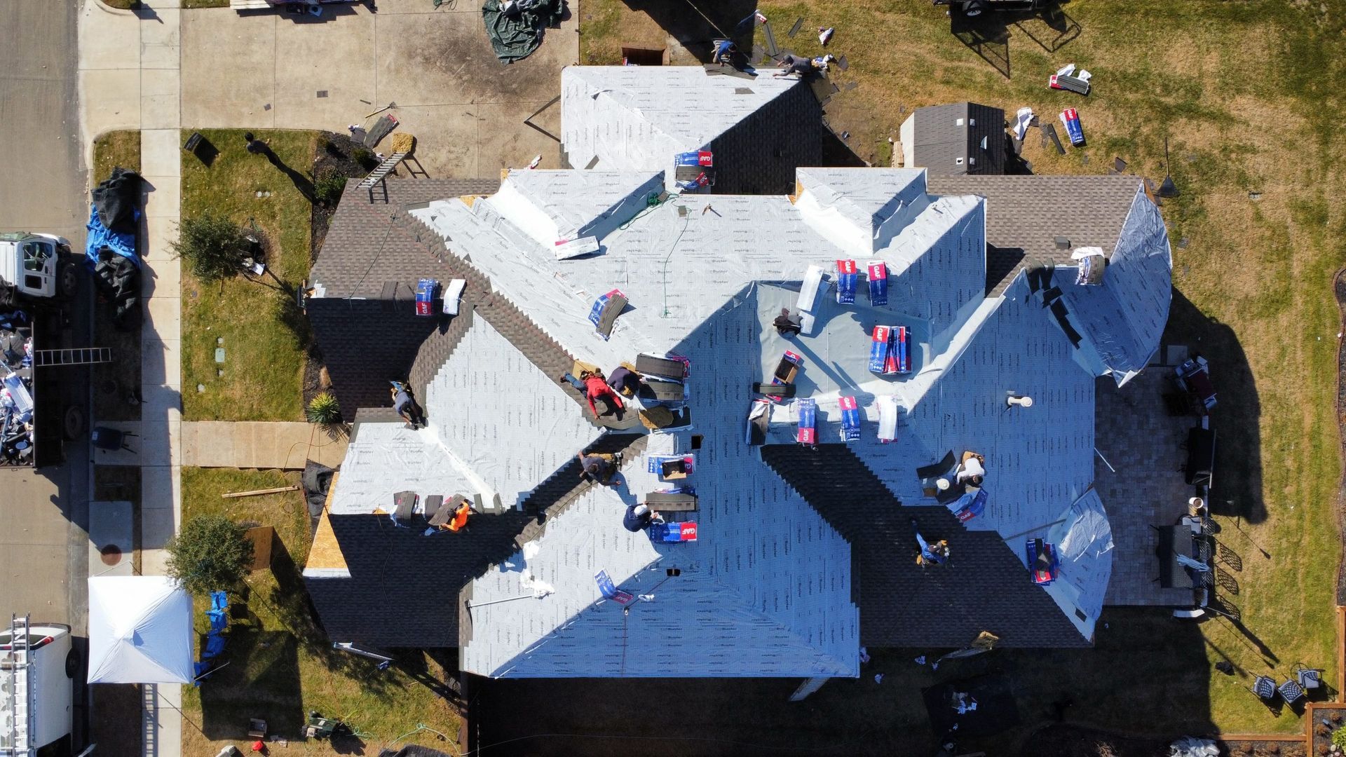 An aerial view of a house with a roof being installed.