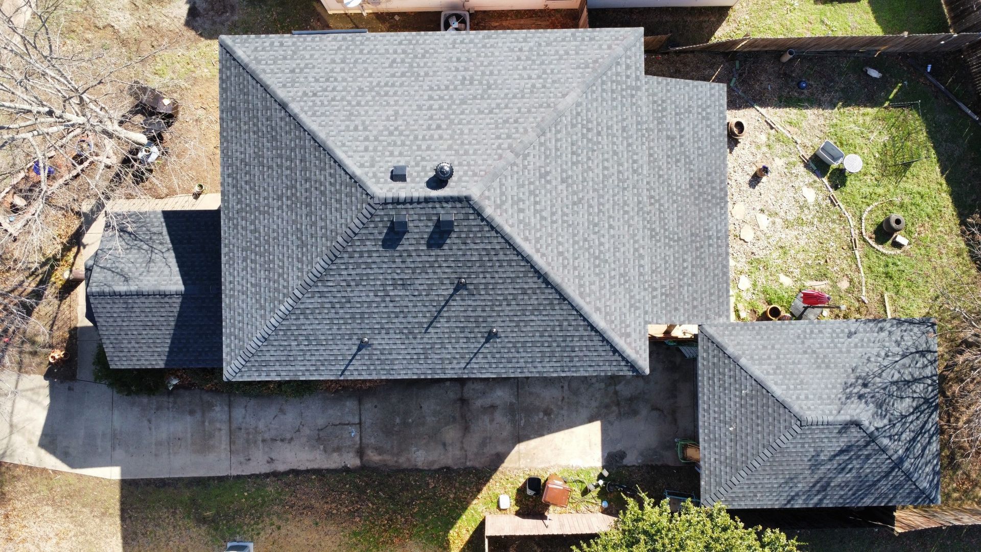 An aerial view of a house with a roof that is being repaired.