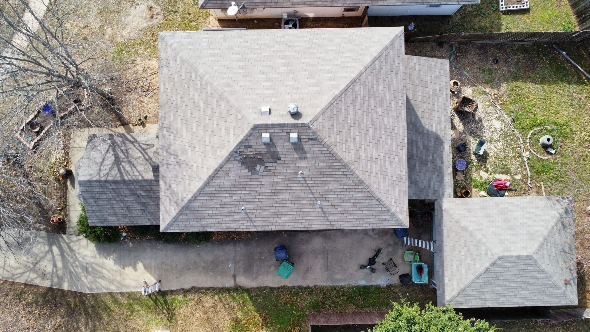 An aerial view of a house with a gray roof.