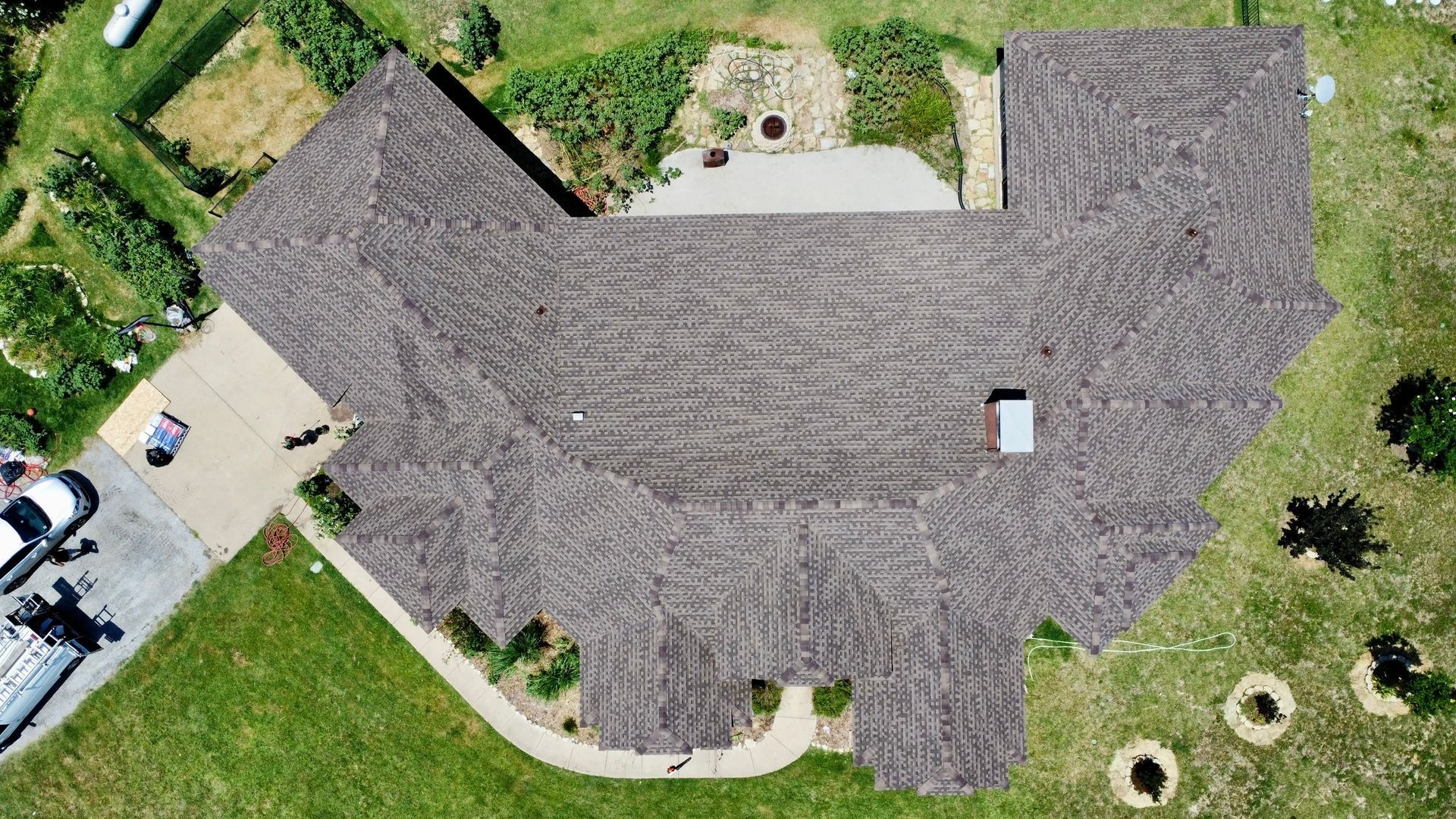 An aerial view of a house with a car parked in front of it.