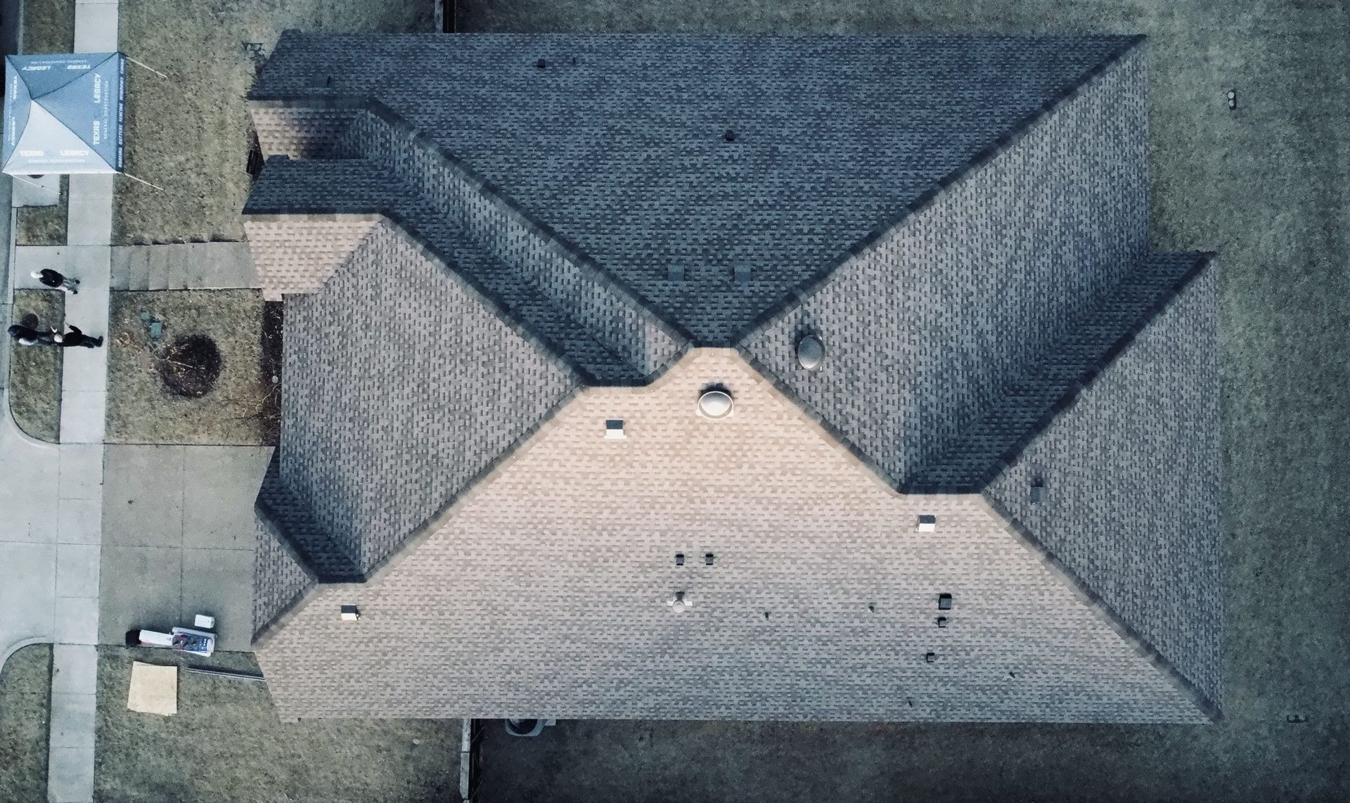 An aerial view of a house with a roof that looks like an envelope.