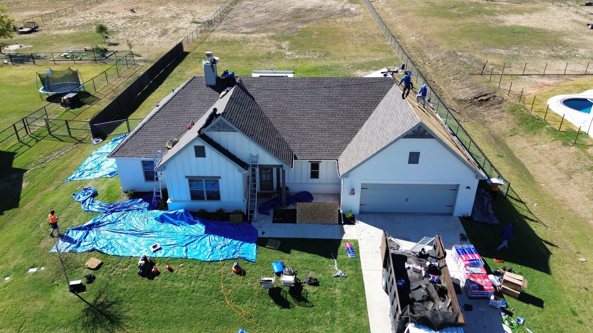 An aerial view of a house under construction with a truck parked in front of it.