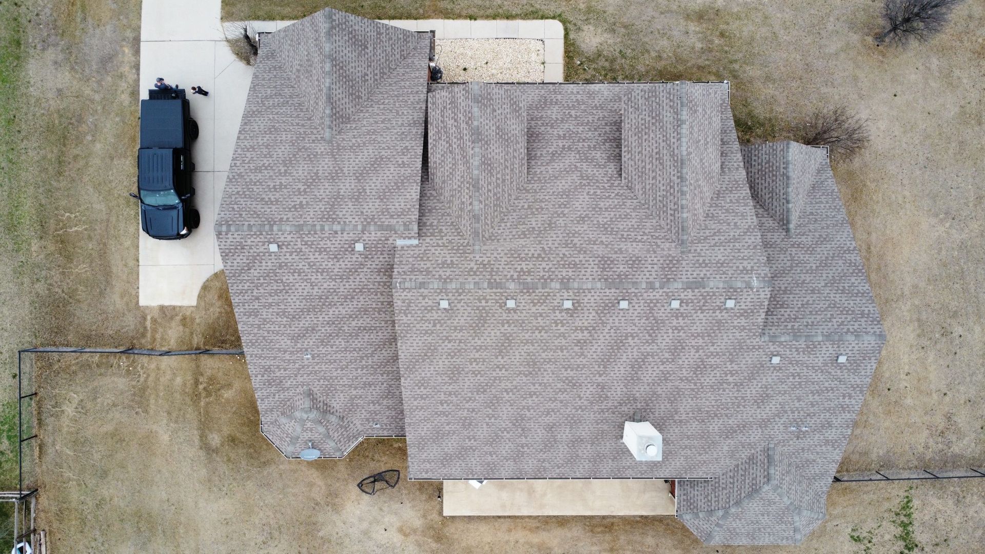 An aerial view of a house with a truck parked in front of it.