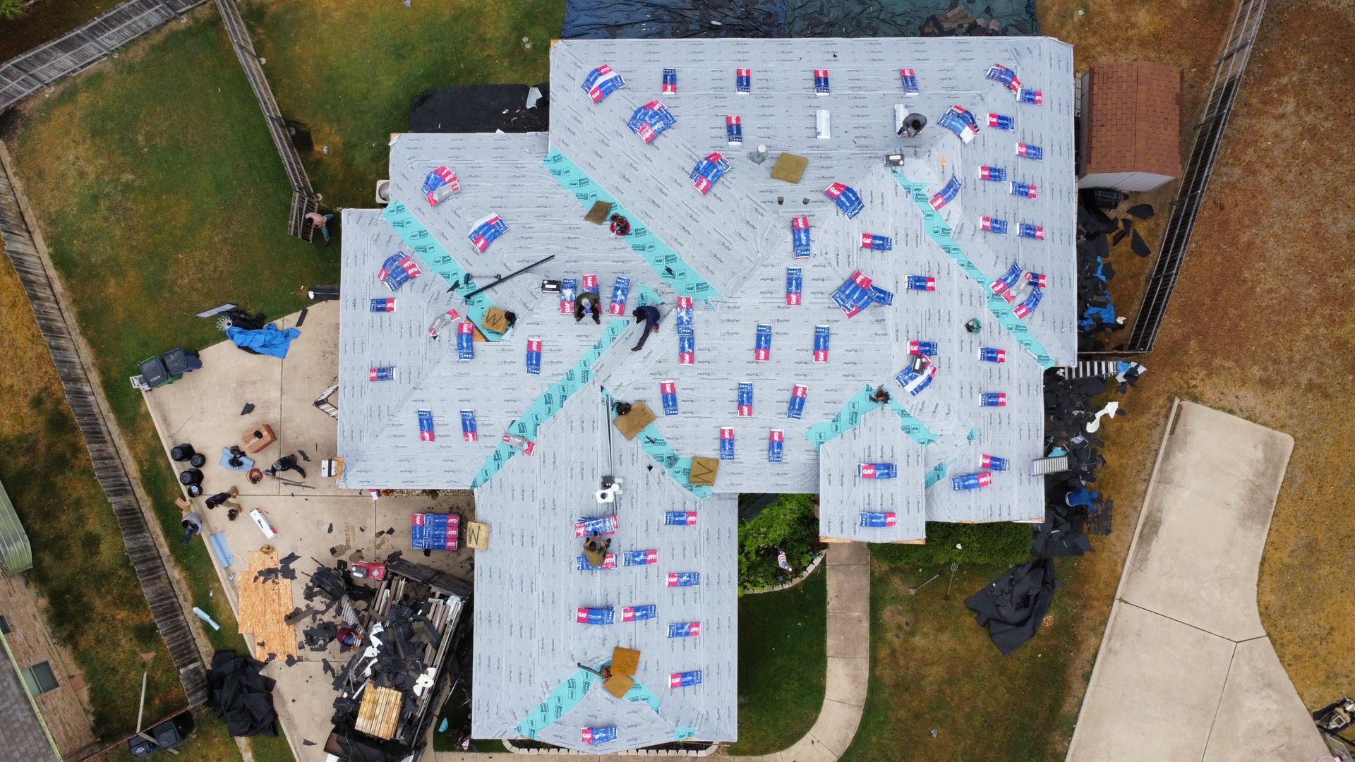 An aerial view of a house with a roof being installed.