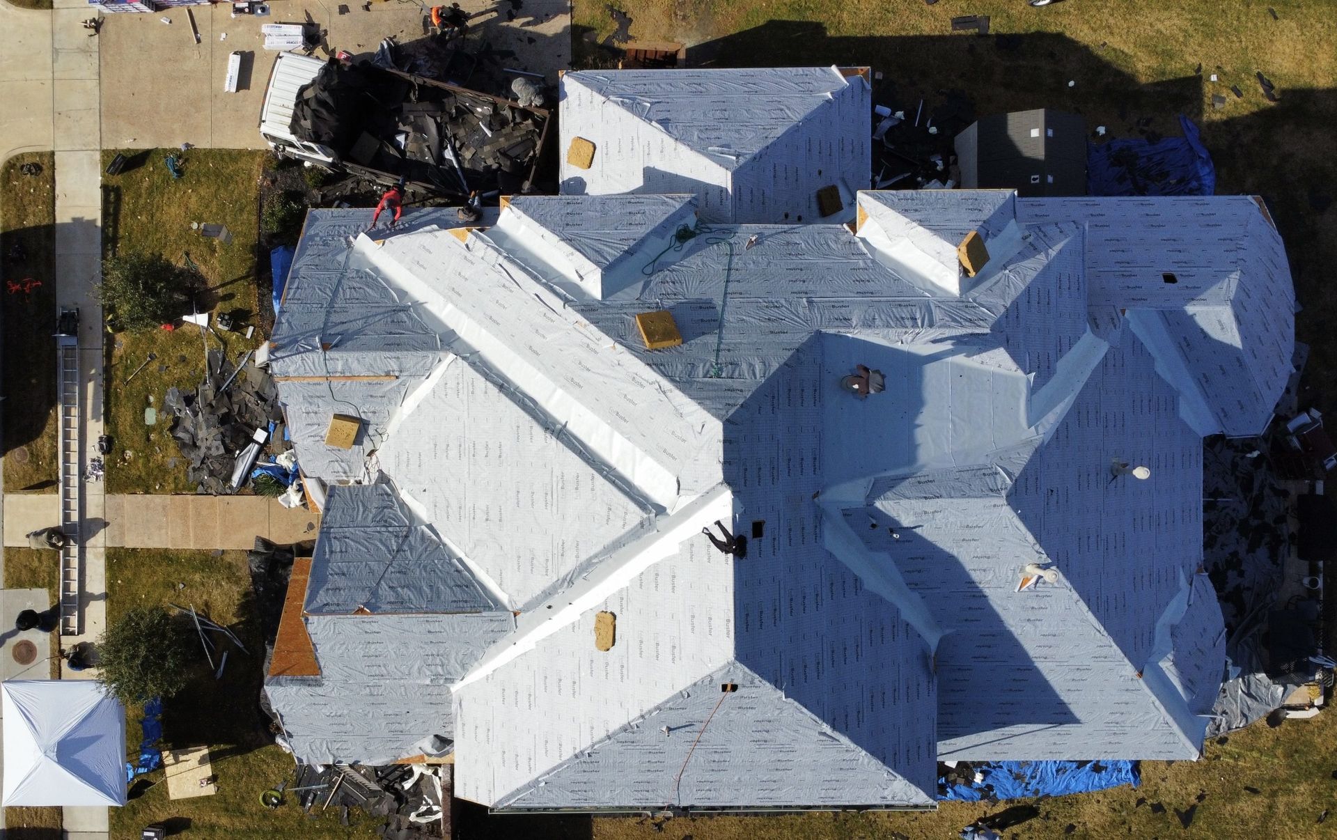 An aerial view of a house with a white roof