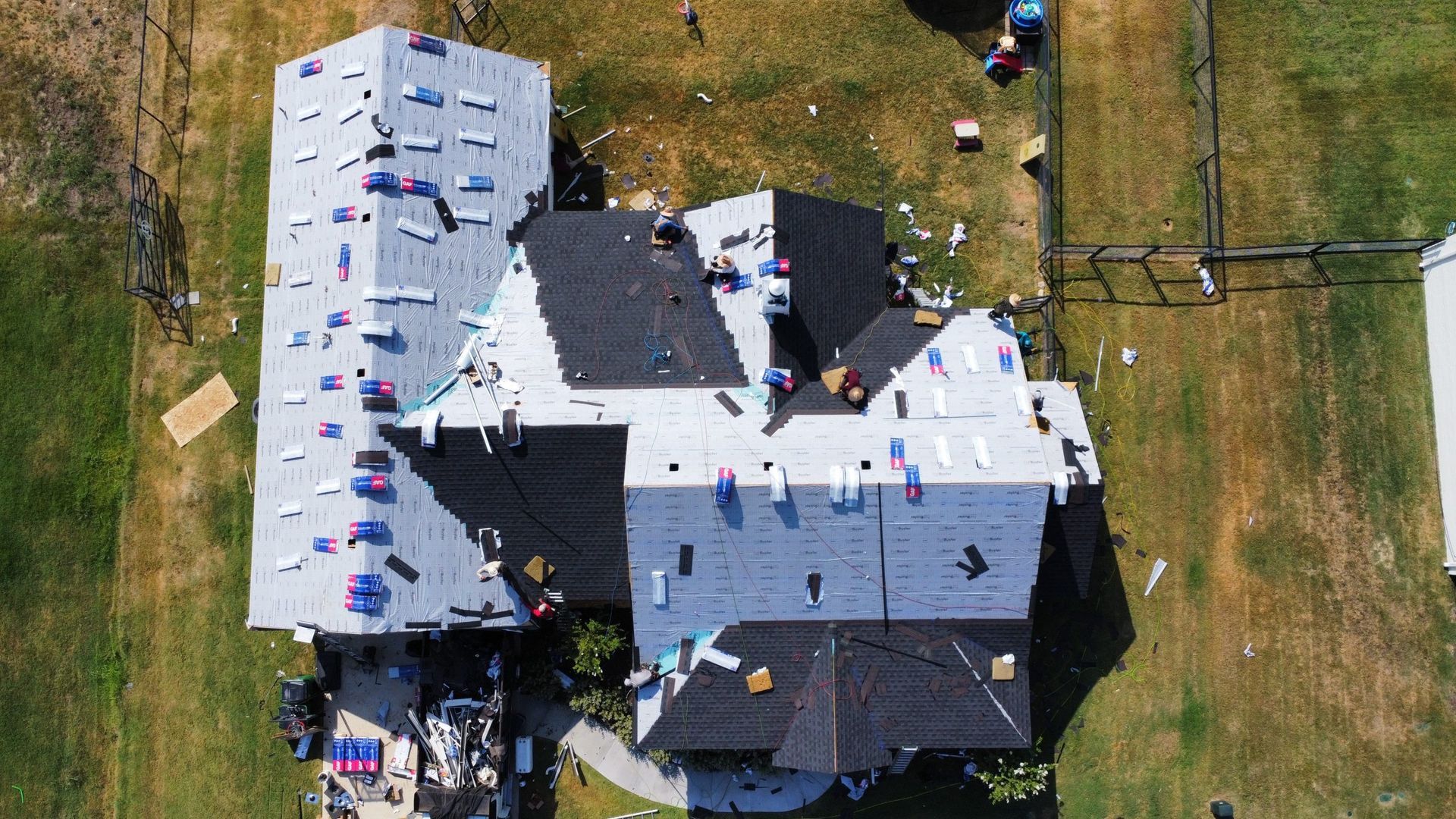 An aerial view of a house being remodeled with a new roof.