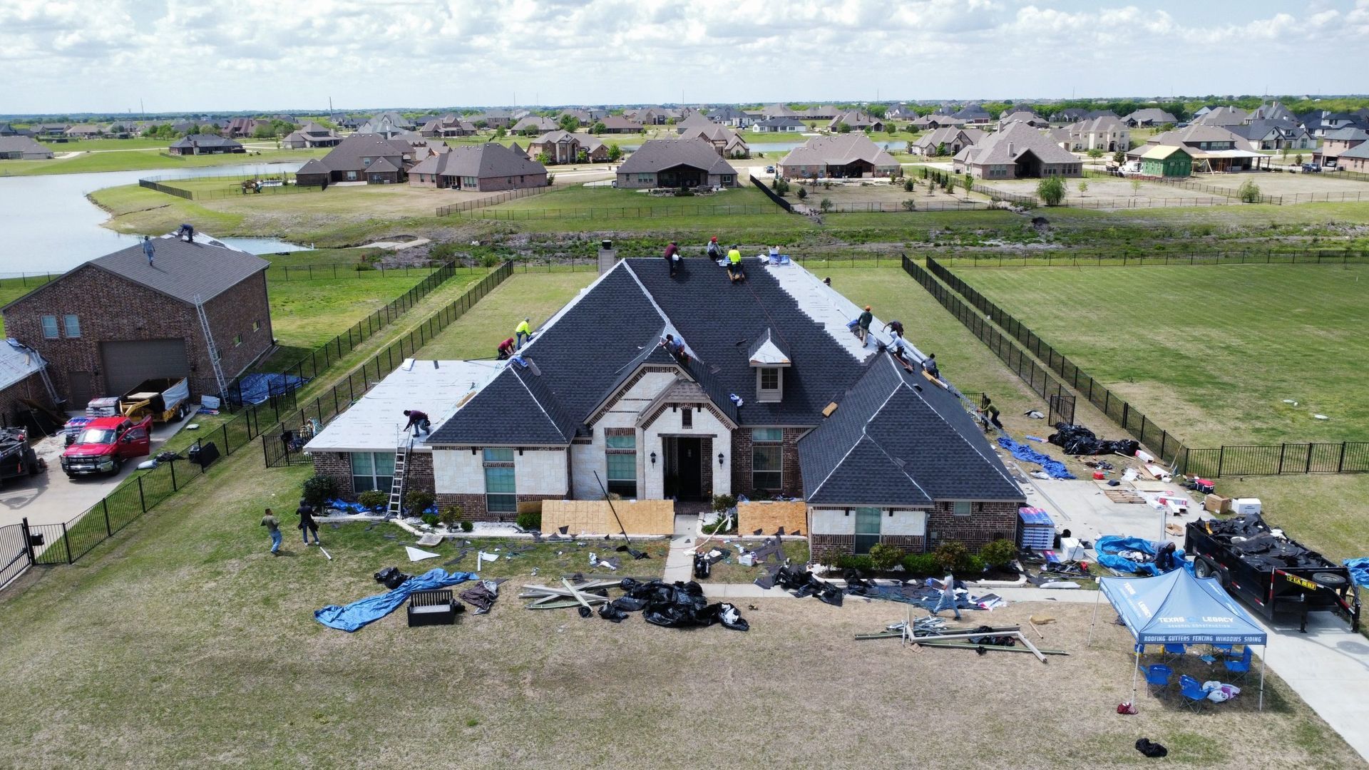 An aerial view of a house under construction in a residential area.
