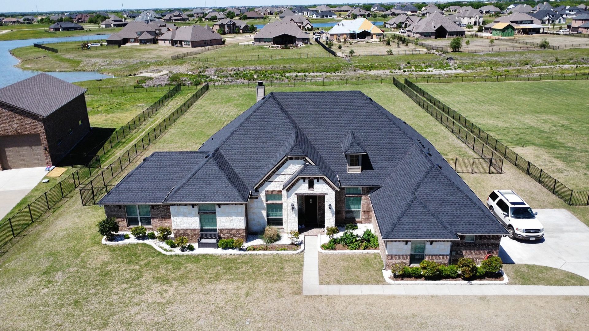 An aerial view of a house with a car parked in front of it.
