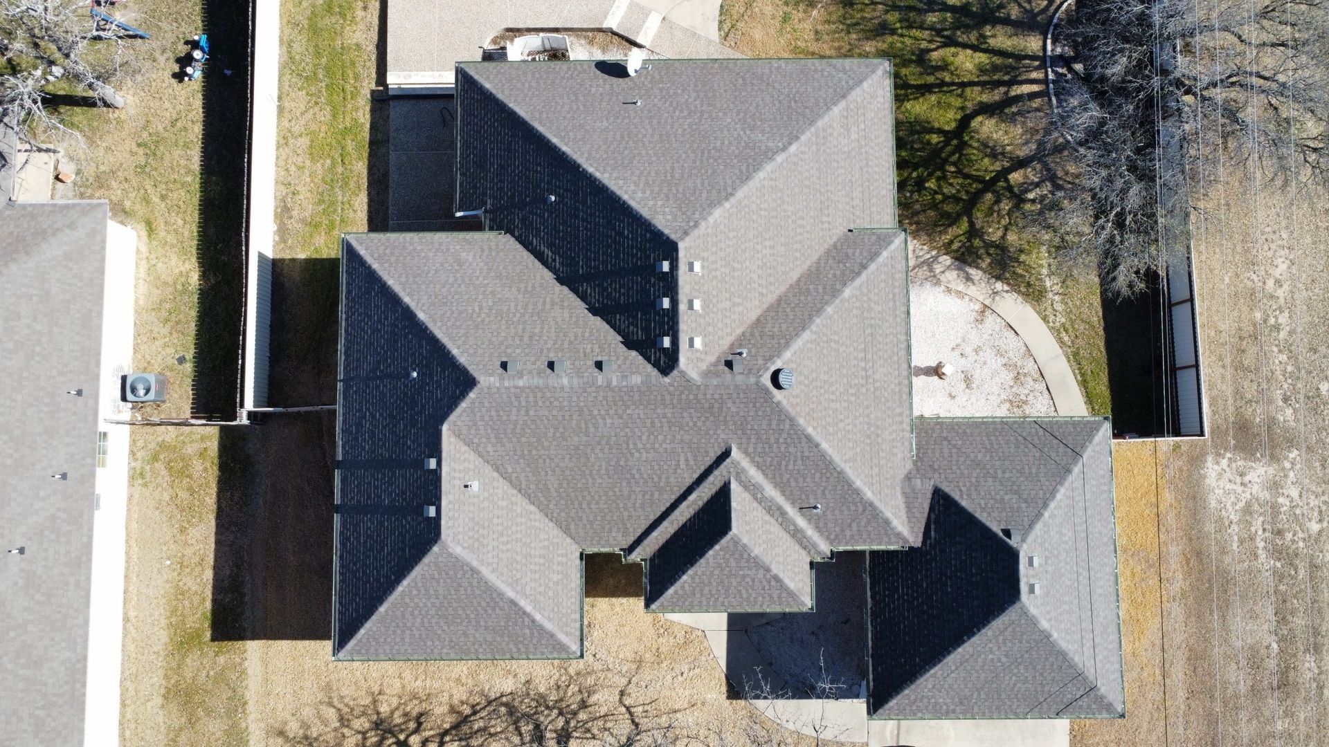 An aerial view of a house 's roof with solar panels on it.