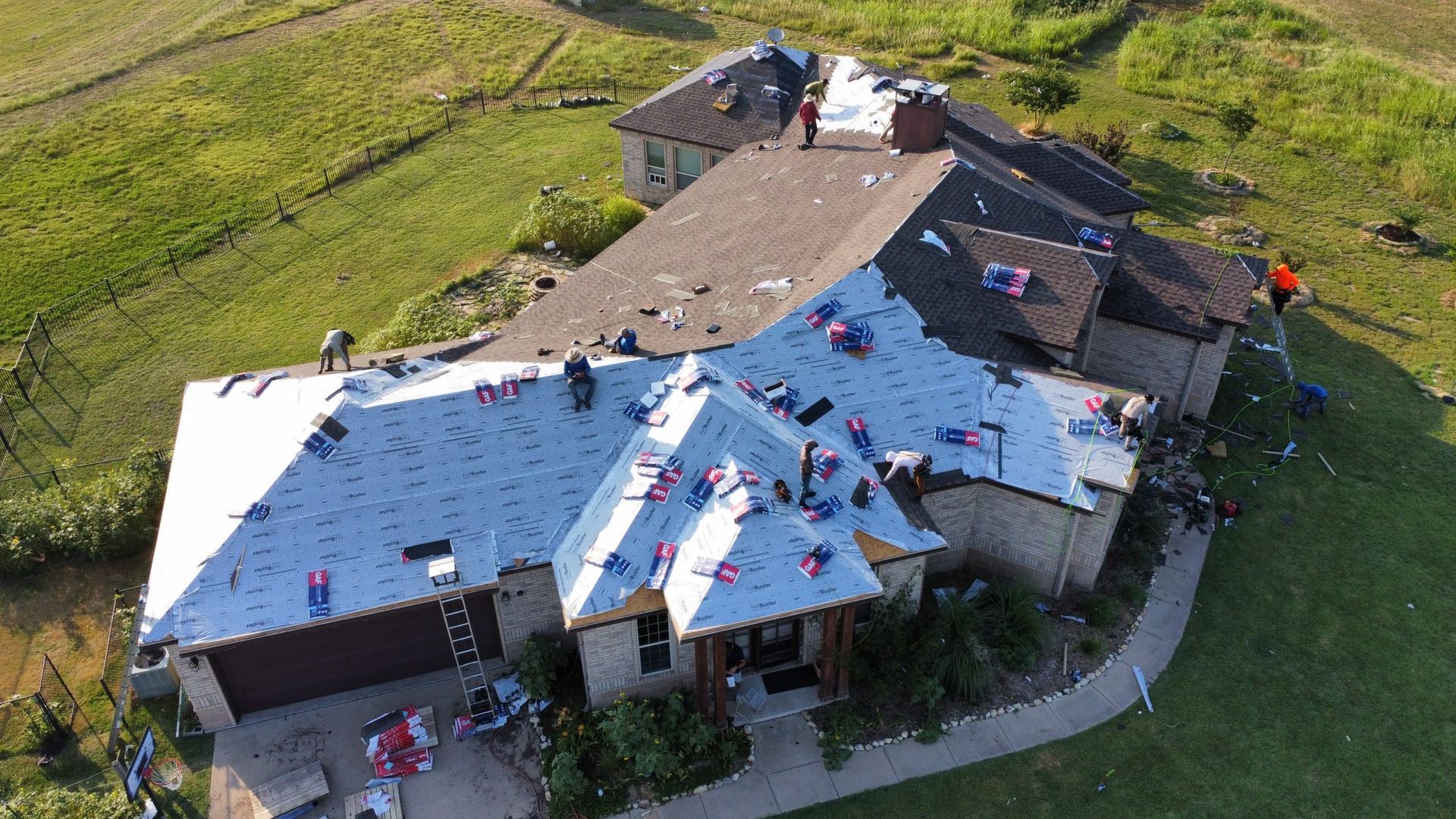 An aerial view of a house with a roof being installed.