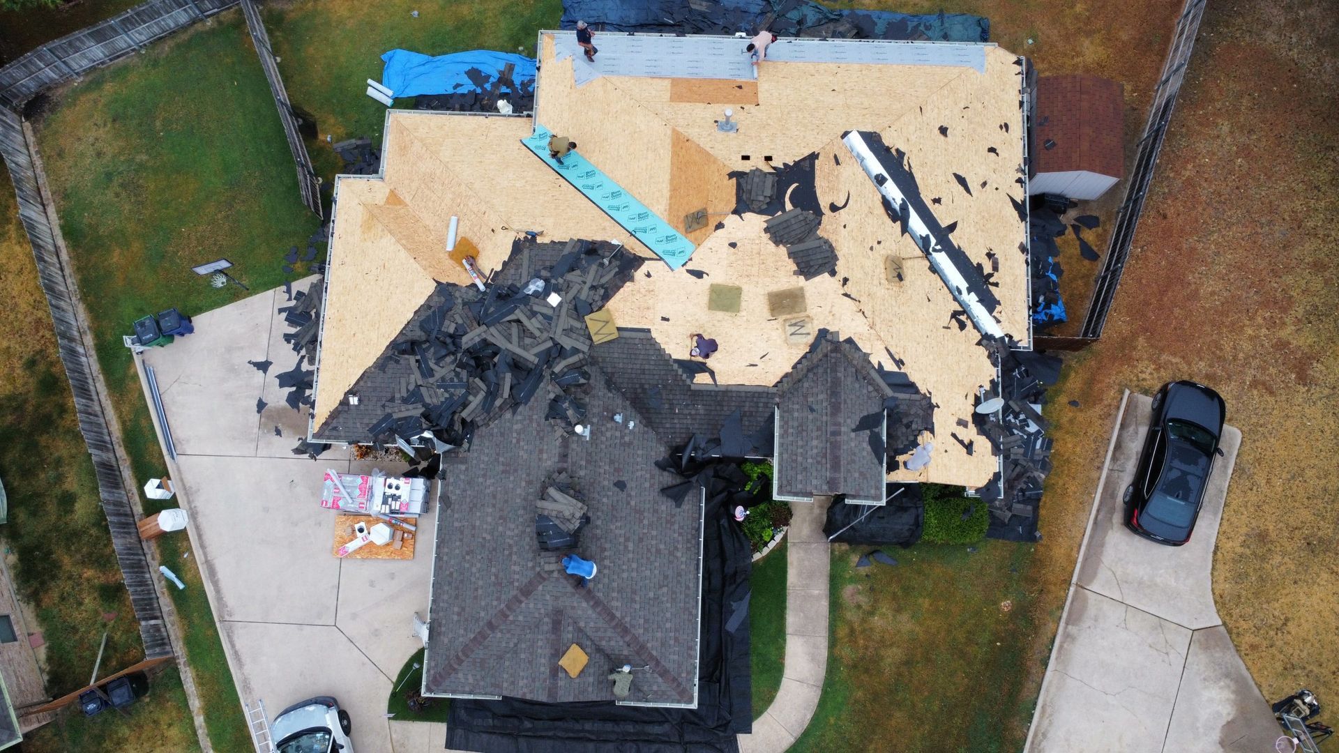 An aerial view of a house under construction with a car parked in front of it.