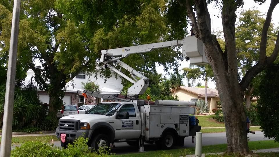 A white truck with a crane on top of it
