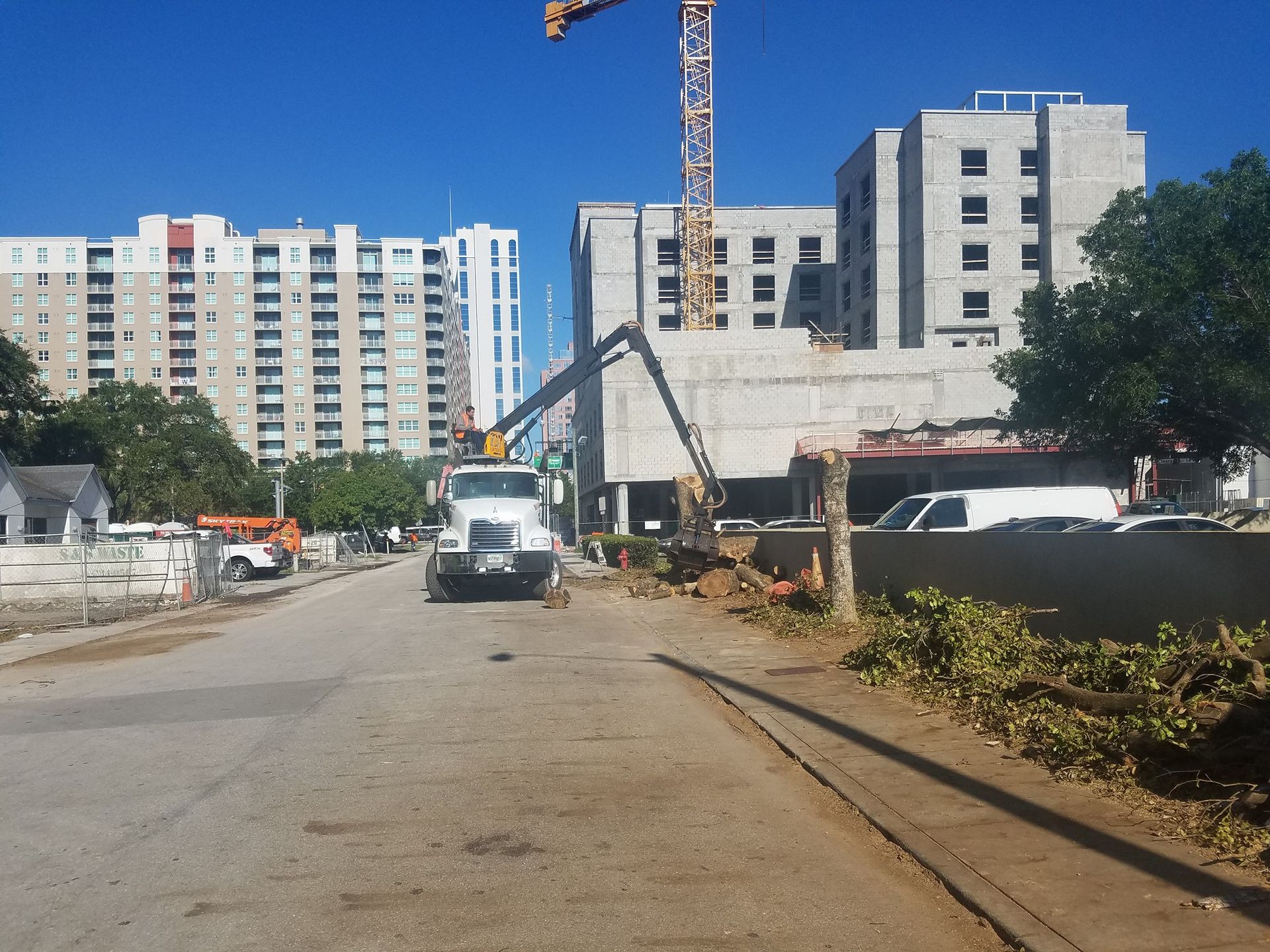 A construction site with a large building in the background