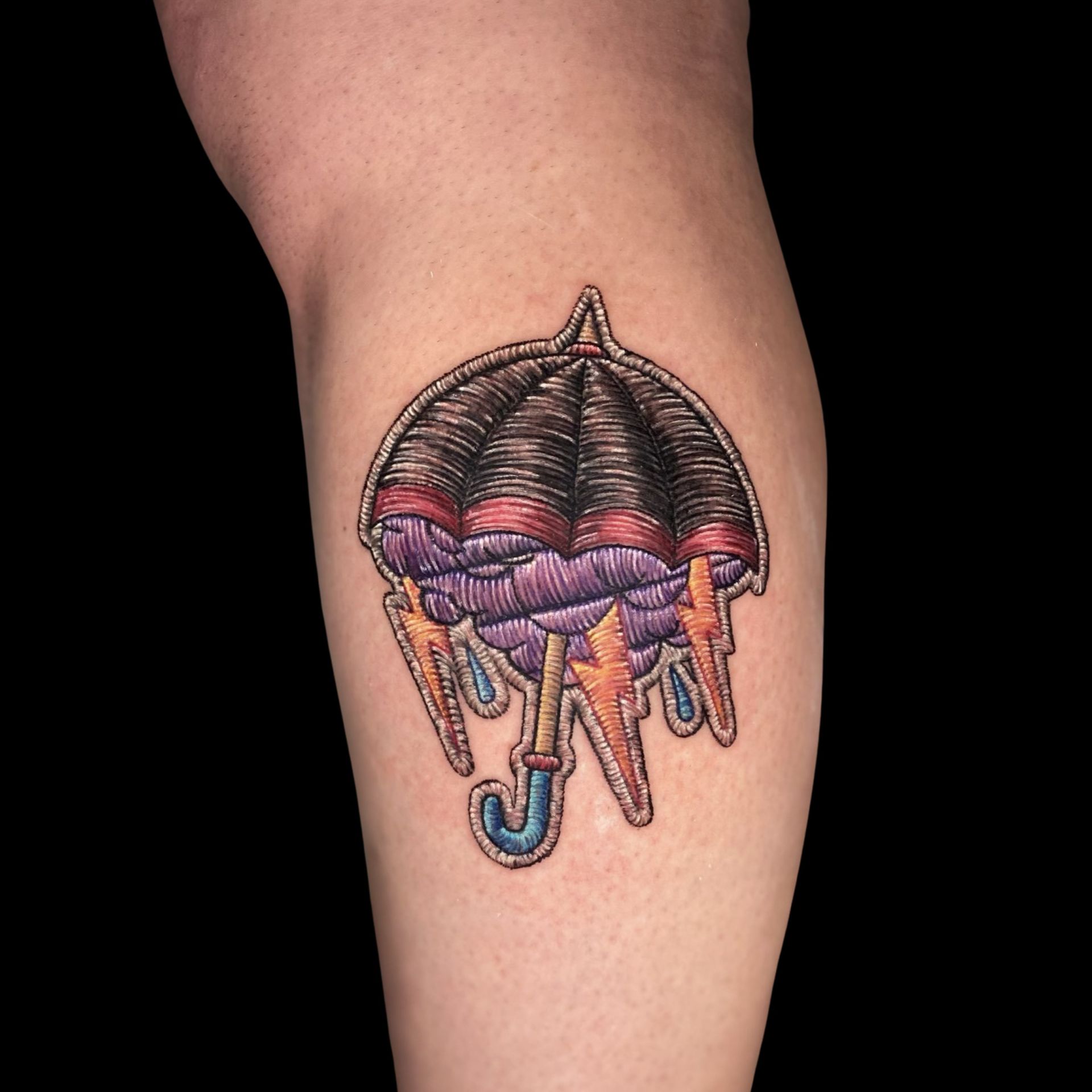 a tattoo of an umbrella with lightning bolts coming out of it