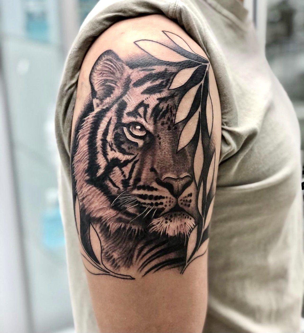 a man has a tattoo of a tiger on his arm