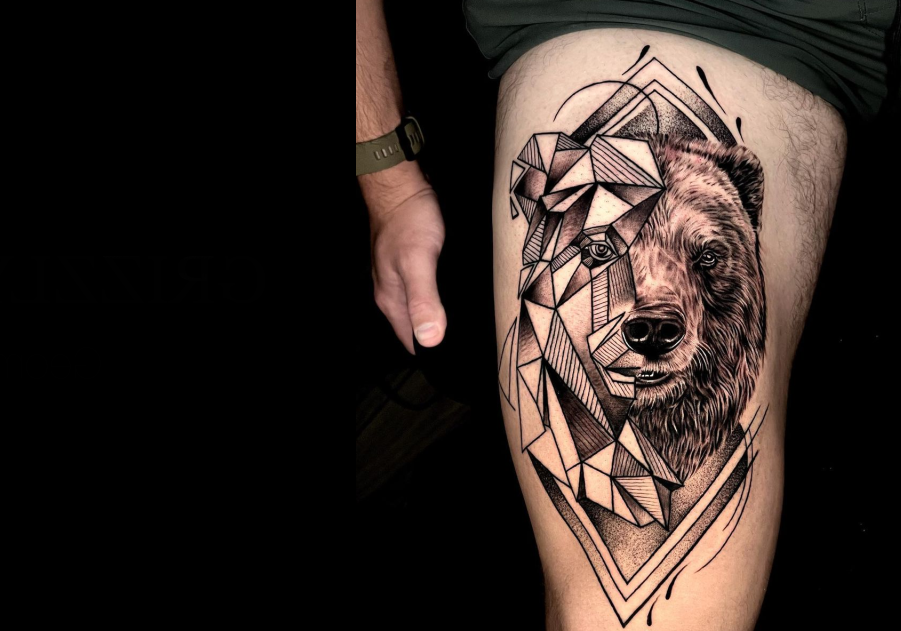 a person has a tattoo of a bear on their thigh .