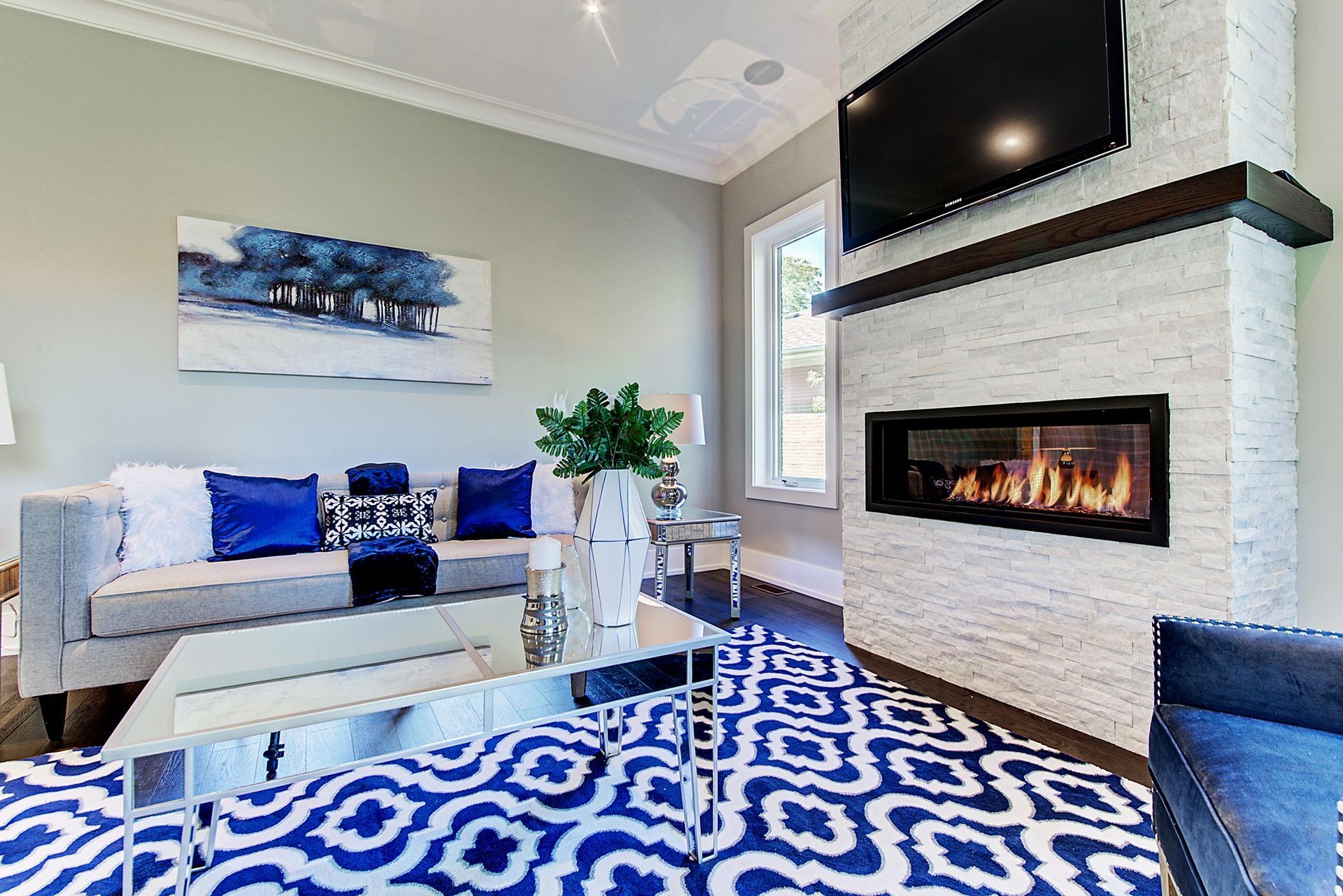 A living room with a fireplace and a flat screen tv.