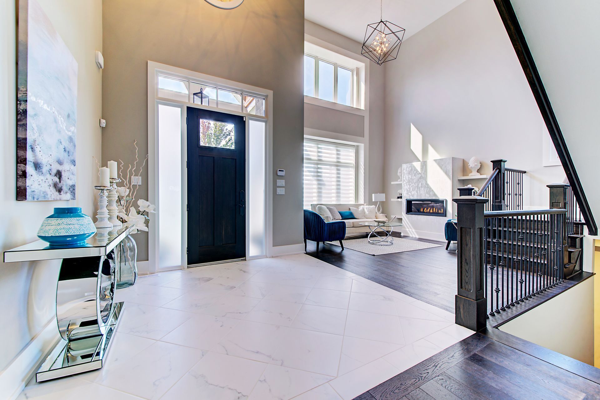 A hallway in a house with a blue door leading to a living room.