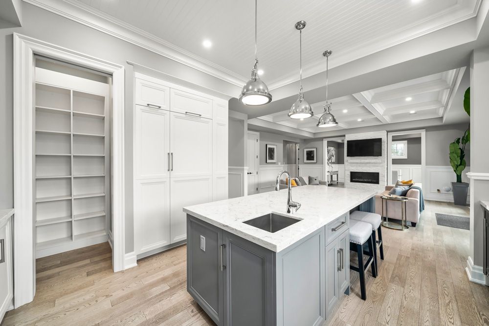 There is a large island in the middle of the kitchen on Tansley Drive by Oakroots Construction.