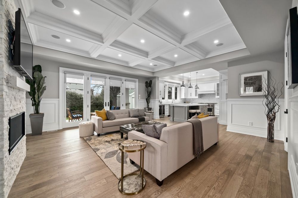 A living room filled with furniture and a fireplace on Tansley Drive by Oakroots Construction
