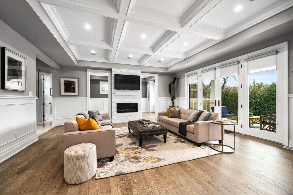 A living room filled with furniture and a fireplace on Tansley Drive by Oakroots Construction