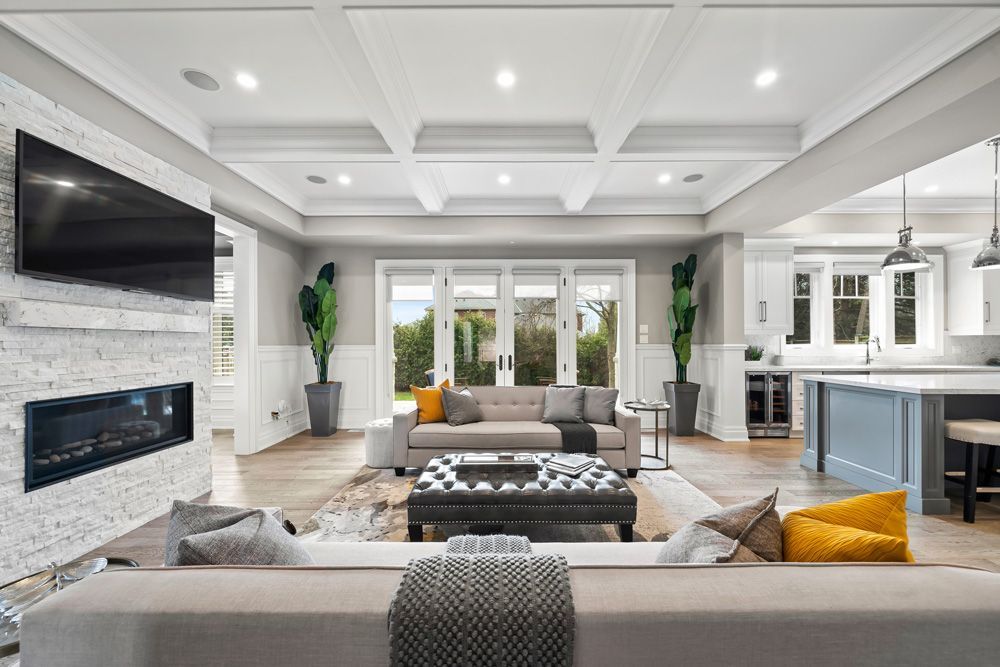 A living room with a couch, fireplace and television on Tansley Drive by Oakroots Construction