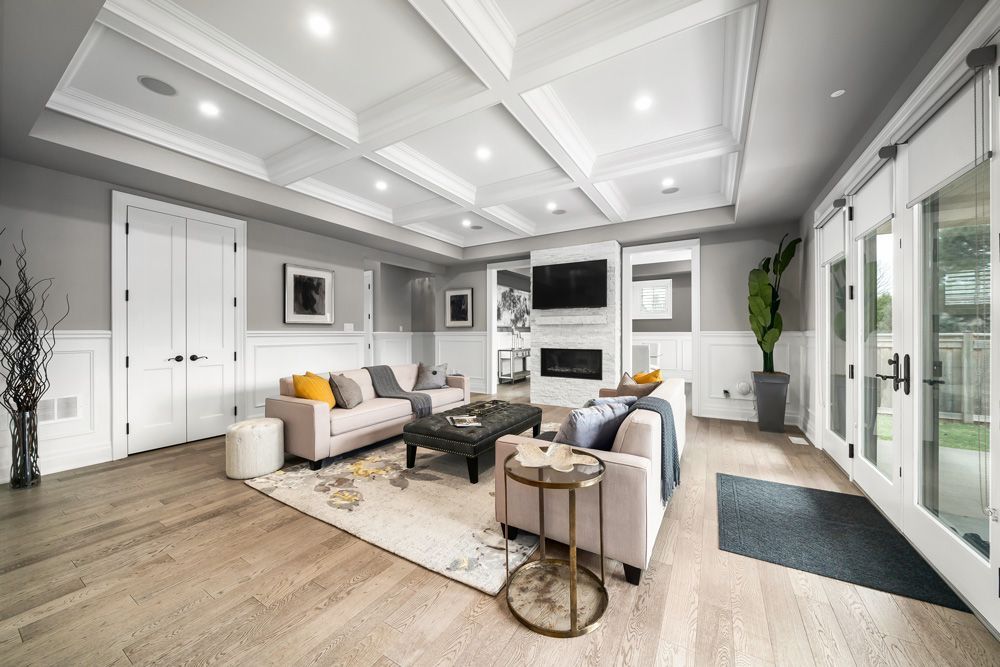 A living room filled with furniture and a fireplace on Tansley Drive by Oakroots Construction
