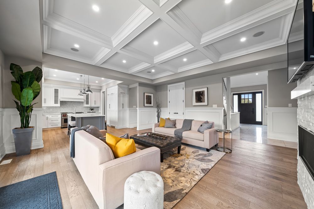 A living room filled with furniture and a fireplace in a house on Tansley Drive by Oakroots Construction