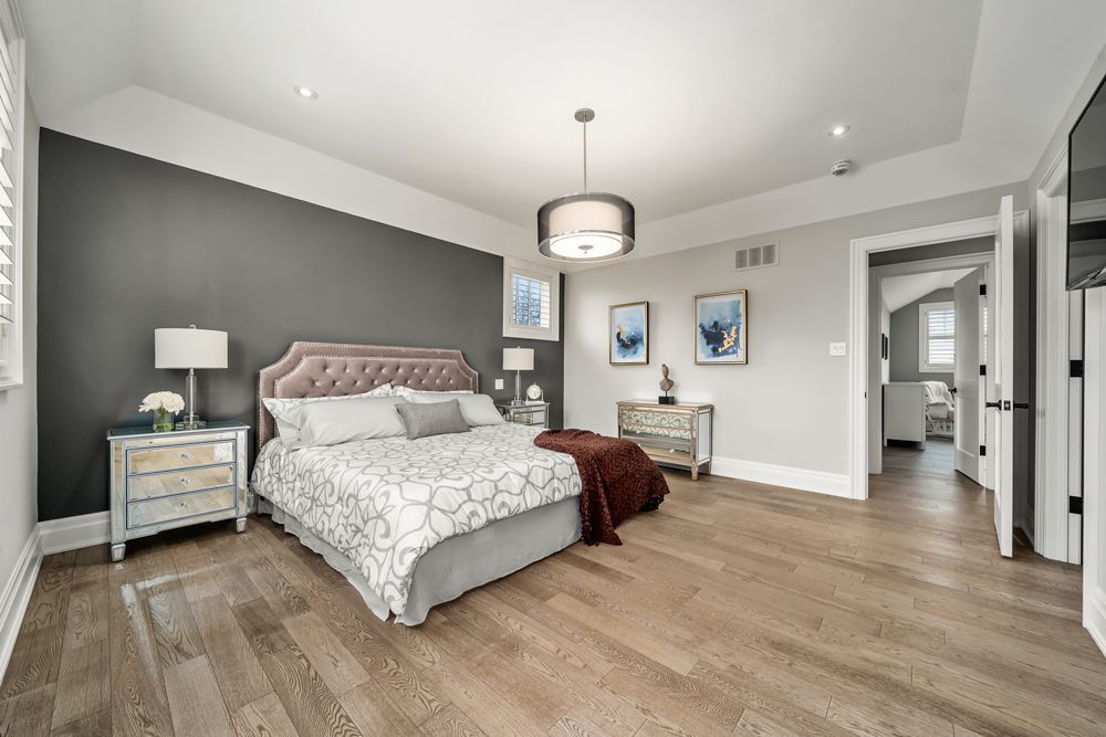 There is a large bed in the middle of the room on Tansley Drive by Oakroots Construction