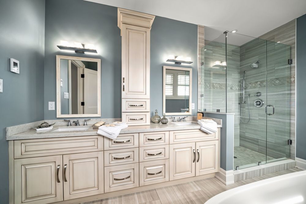 A bathroom with two sinks, two mirrors and a walk-in shower on Tansley Drive by Oakroots Construction