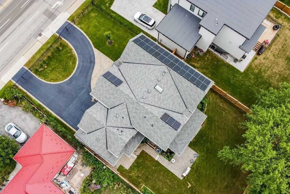 An aerial view of a house with solar panels on the roof