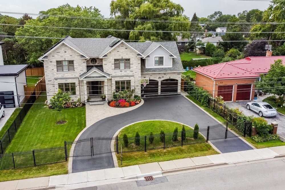 An aerial view of a large house with a driveway leading to it.
