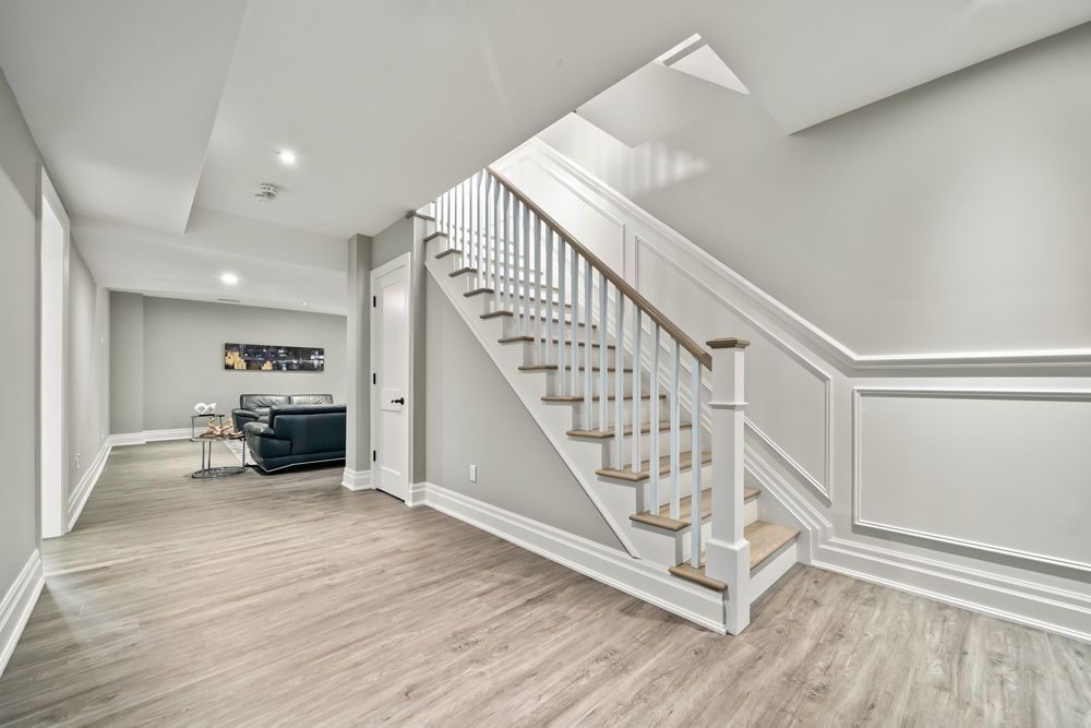 There is a staircase leading up to the second floor of a house on Tansley Drive by Oakroots Construction