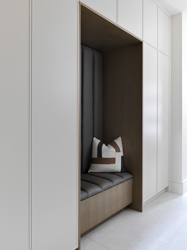 There is a pillow on the bench in the corner of the room in Angelene St by Oakroots Construction